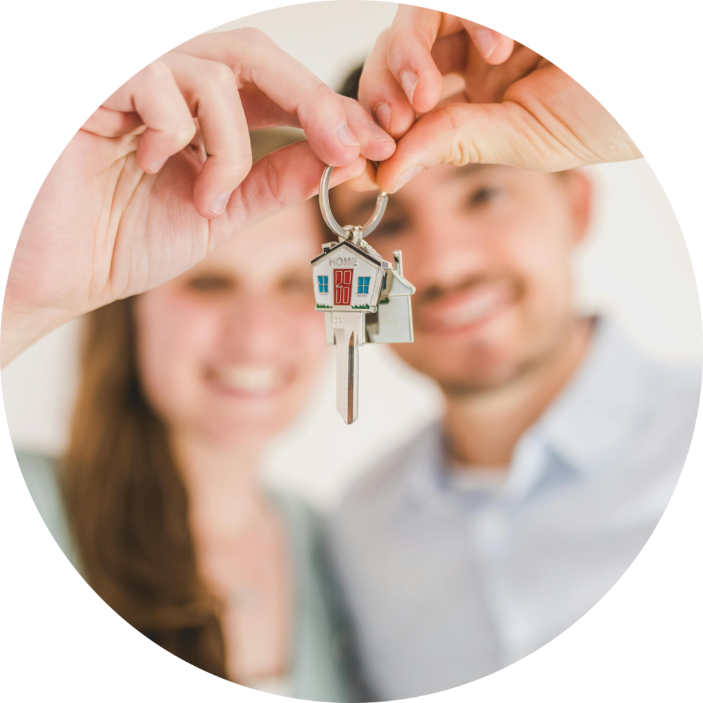 Couple holding key to new home.